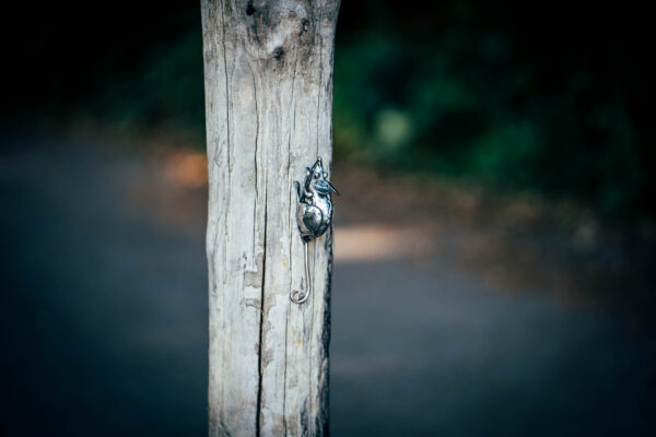 Mouse hiding on the Owl garden sculpture